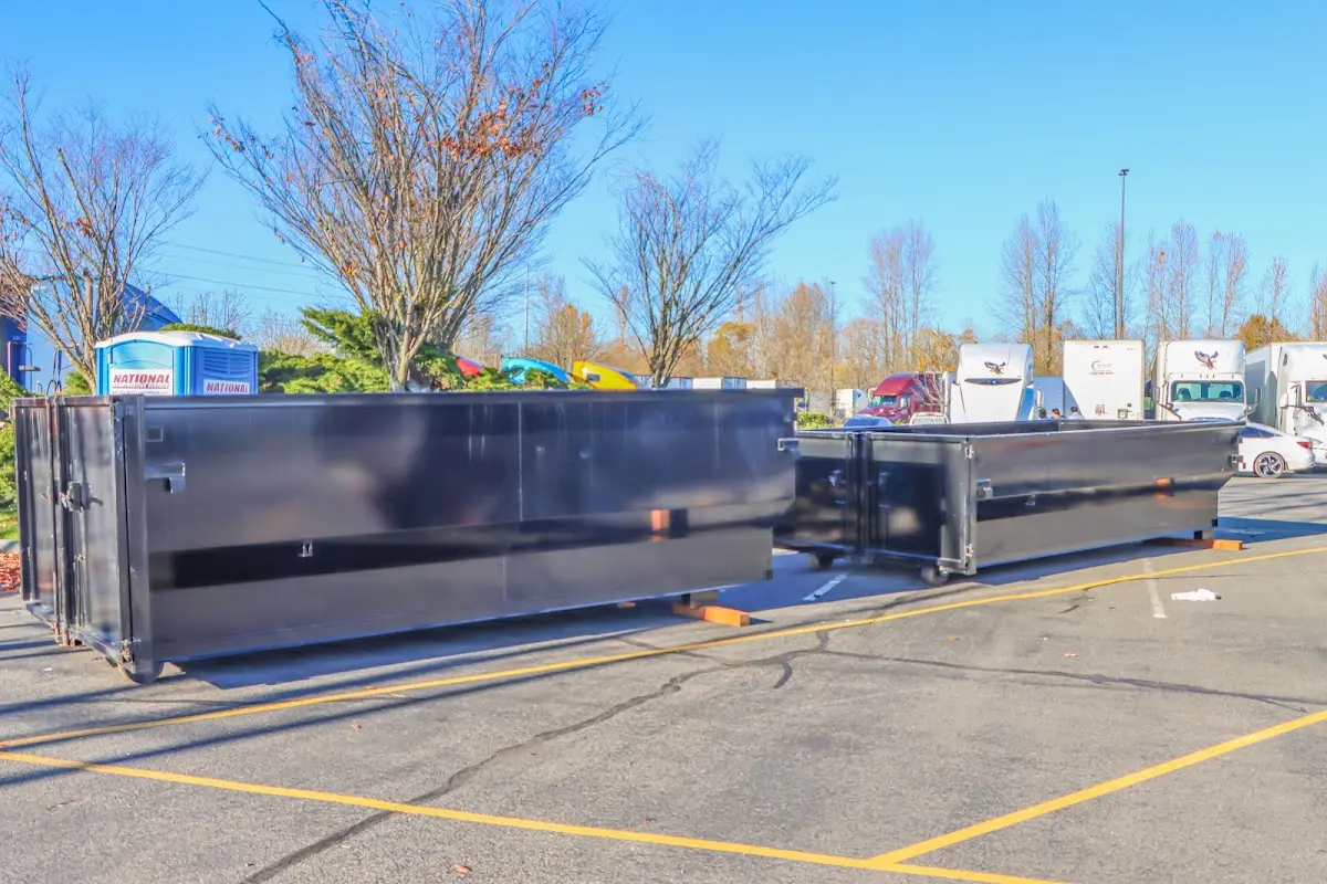 Professional dumpster rental service with roll-off container on residential driveway in Buckley